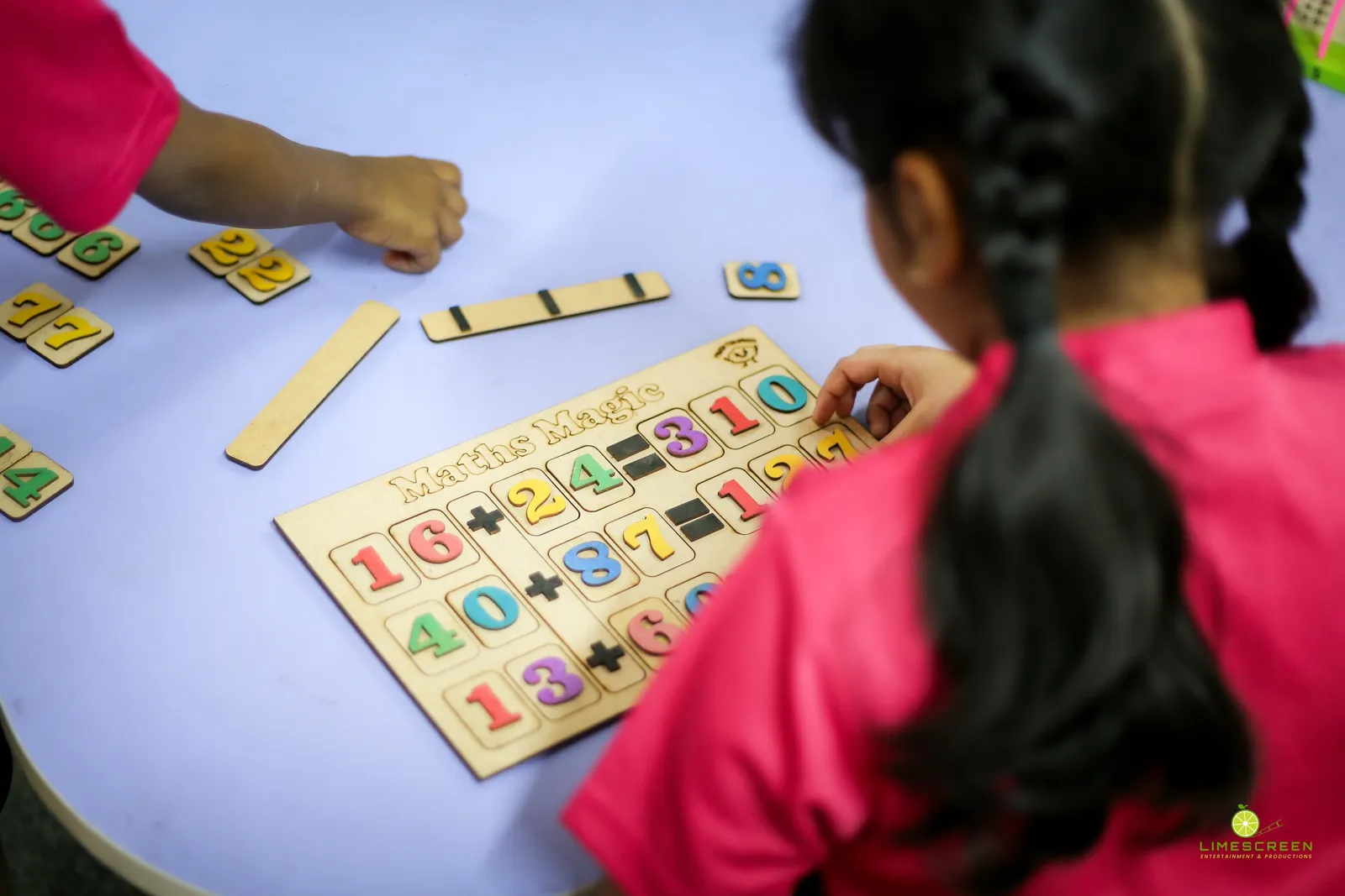 Young student solving a Maths Magic number board