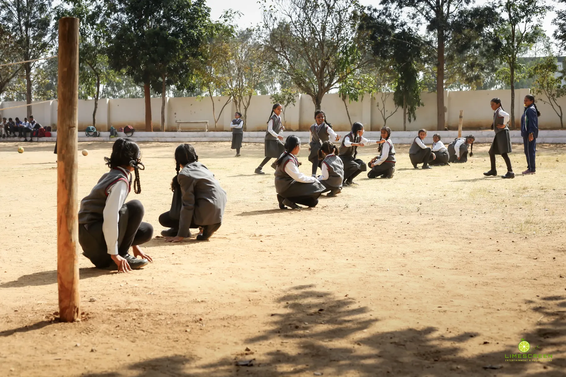 Students playing kho-kho on the school ground
