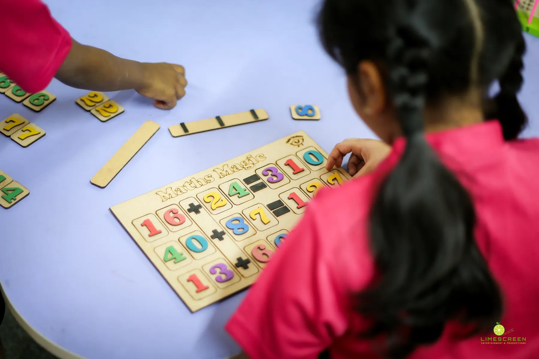 A young child learning numbers with hands-on learning materials